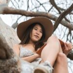 Books - A Woman Sitting on a Tree Branch